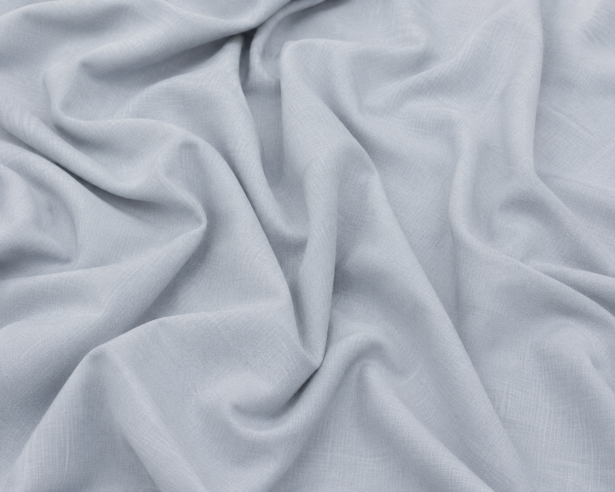 Light gray textured fabric with soft draped folds and a woven linen-like surface.
